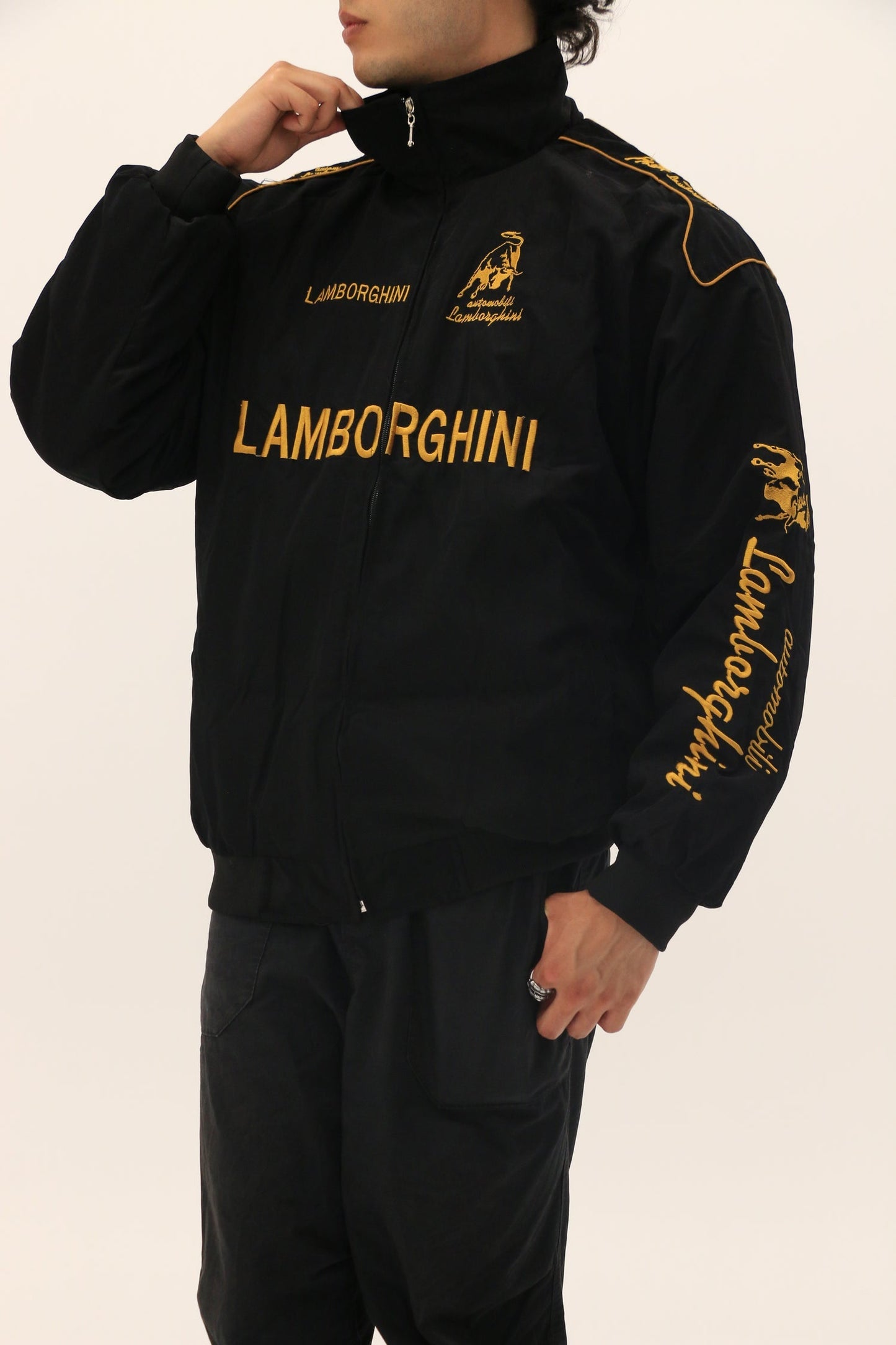 Black tracksuit with Lamborghini branding on a white background