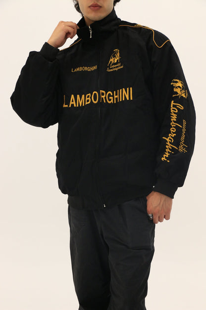 Male Model wearing a black Lamborghini tracksuit with gold text on a plain background